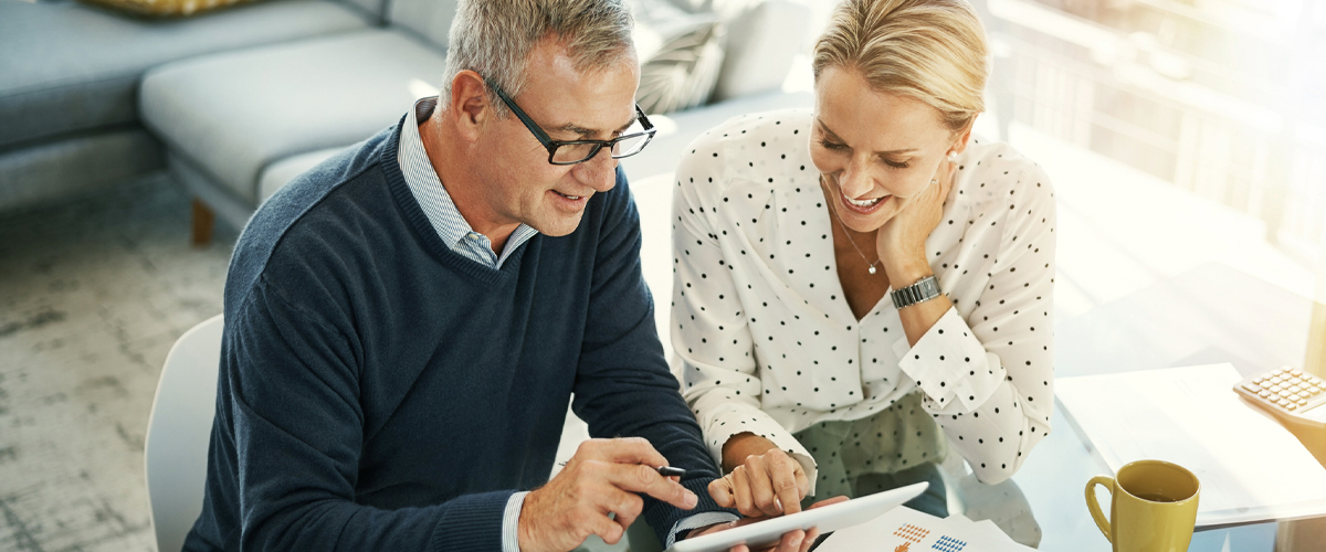 Photo of a couple at a dining table with using a tablet