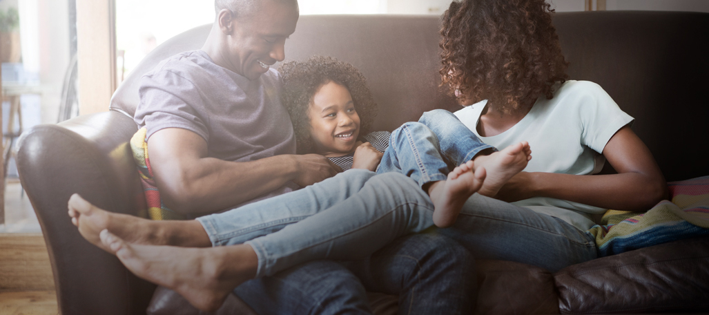 A family sitting on a sofa.